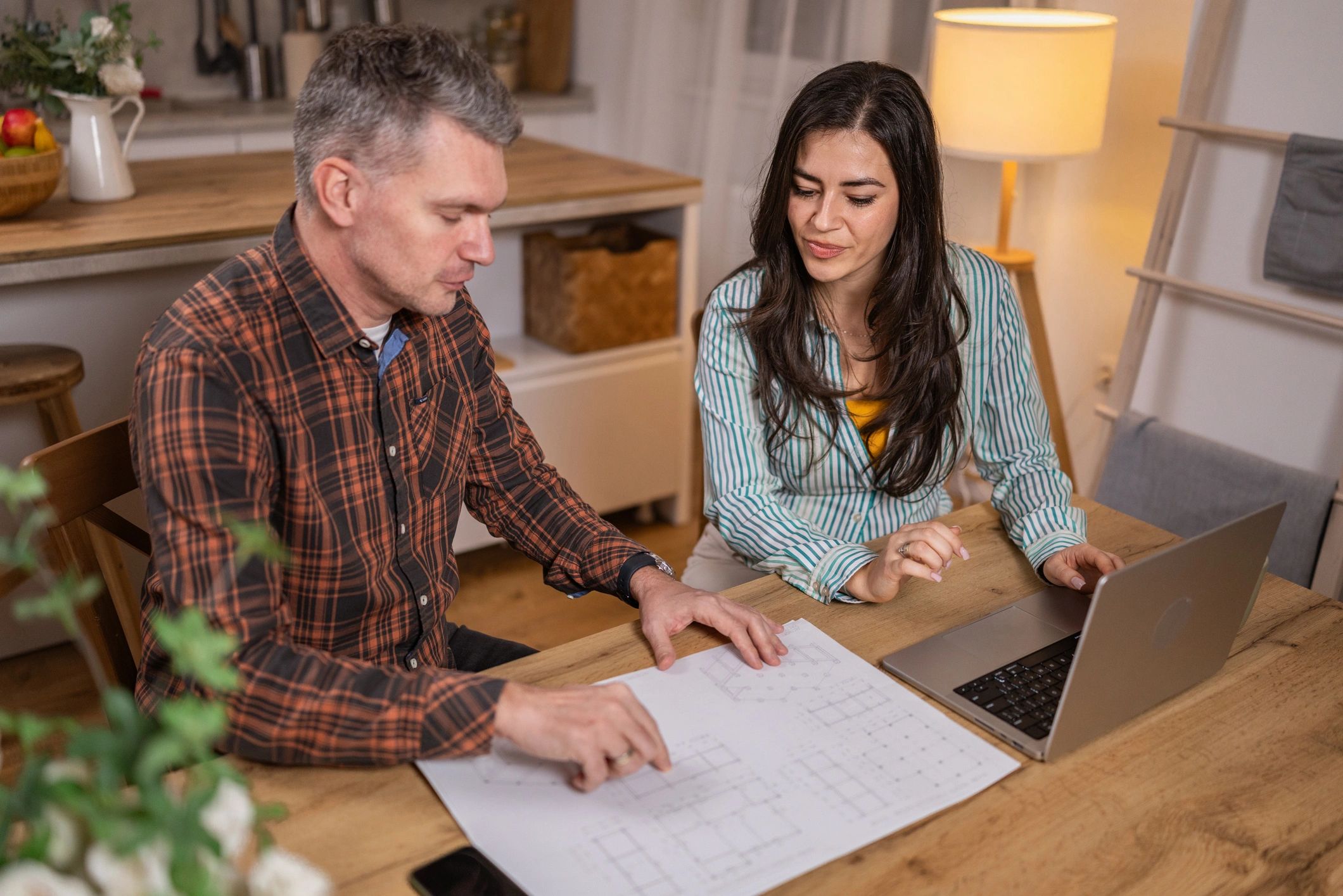 Homeowners reviewing plans and timeline for a backyard ADU